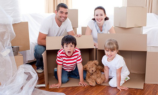 Family with moving boxes, happy with moving quotes in Summit, NJ